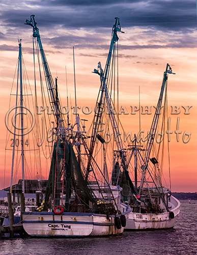 While traveling to Charleston, South Carolina I visited Kiawah Island. My wife and I were enjoying dinner at a nearby restaurant when I observed the beginning of a beautiful sunset. A short distance away was a fishing pier with two docked shrimp boats. The scene captured my eye.