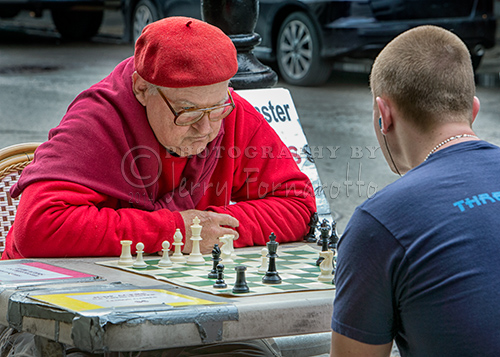 Jude Acers plays against all comers in a New Orleans downtown gazebo while wearing a red beret. 