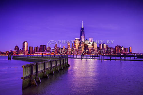 The New York City skyline at sunset, seen from Jersey City, New Jersey attracts sightseers from around the world. From this vantage point you can see lower Manhattan, the new Freedom Tower and Battery Park.