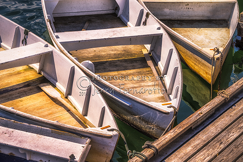 A group of dinghies moored at the dock at Perkins Cove, Ogunquit, Maine.