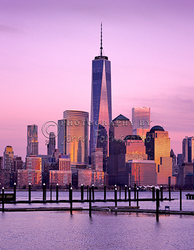 This is photo of Lower Manhattan, NYC, was taken from Jersey City, New Jersey at dusk. The Freedom Tower is in the center. To the left of the tower is the Woolworth Building. Behind the Woolworth Building is the Beekman Tower. Right of the Freedom Tower is the World Financial Center.