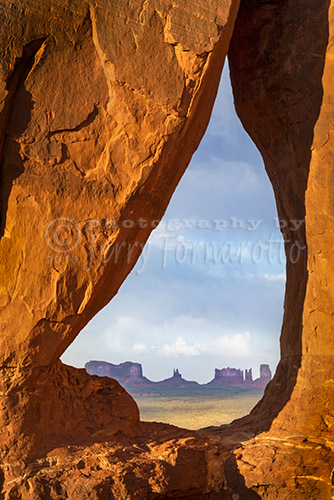 Teardrop Arch is in Nizhoni Valley within Monument Valley. The arch frames the buttes of the tribal park.