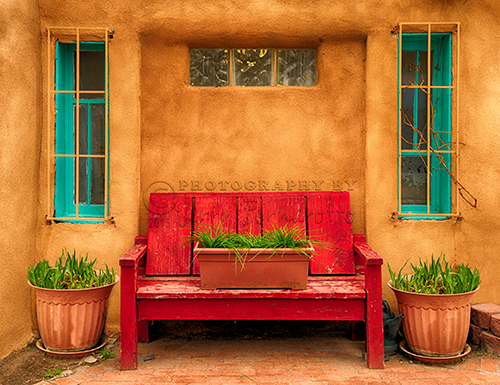 A bright red bench in "Old Town" Albuquerque, New Mexico.
