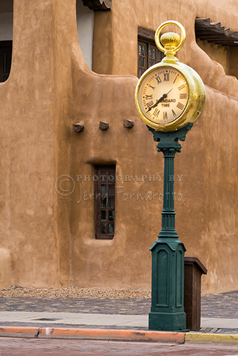 Santa Fe Square Clock stand in front of the New Mexico Museum of Art at the corner of Lincoln and W. Palace Aves.