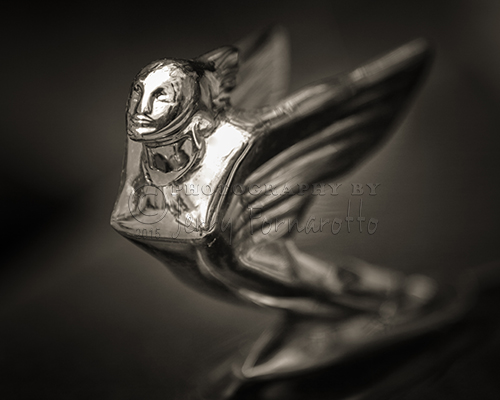 A close-up photo of a 1938 V16 Cadillac hood ornament. The photo was taken with a Canon 1Dx, 70-200mm lens at 200mm, f2.8. The image was processed with Photoshop HDR, NIK Color Efex Pro 4, NIK Viveza 2 and NIK Dfine 2.