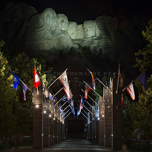 A night time view of Mount Rushmore from the promenade. 