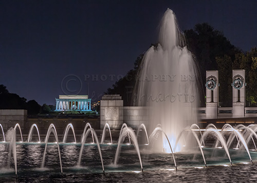 A night photo of the World War II and Lincoln Memorials