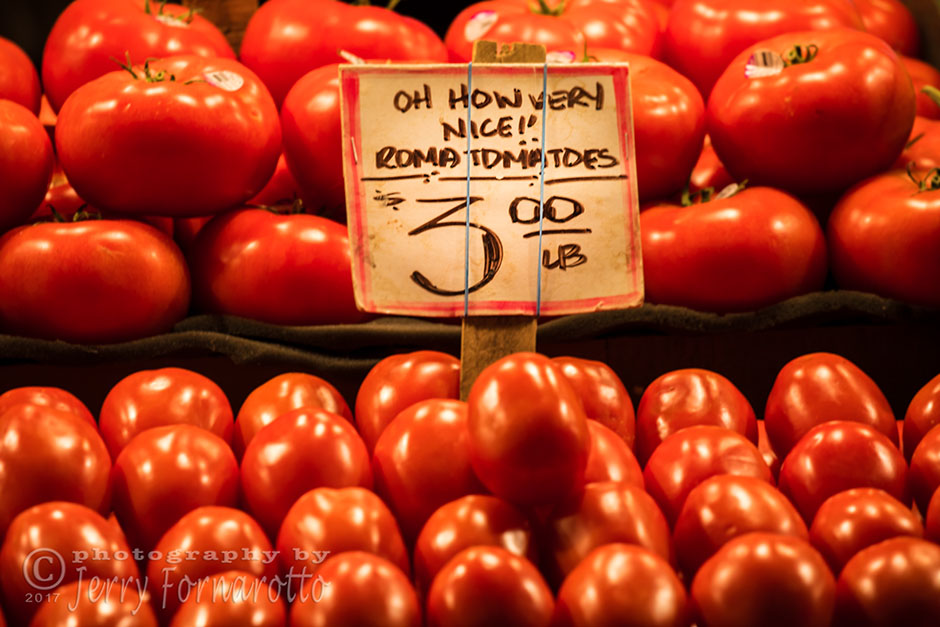 Tomatoes for sale at the Pike Place Market. This public market overlooking the waterfront in Seattle, Washington. Canon 5D MKIV, Canon 100-400mm set to 400mm, 1/125sec, f6.3