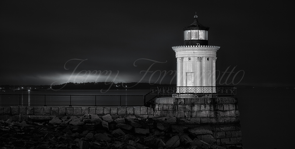 Portland Maine, Bug Lighthouse at end of breakwater in monochrome.